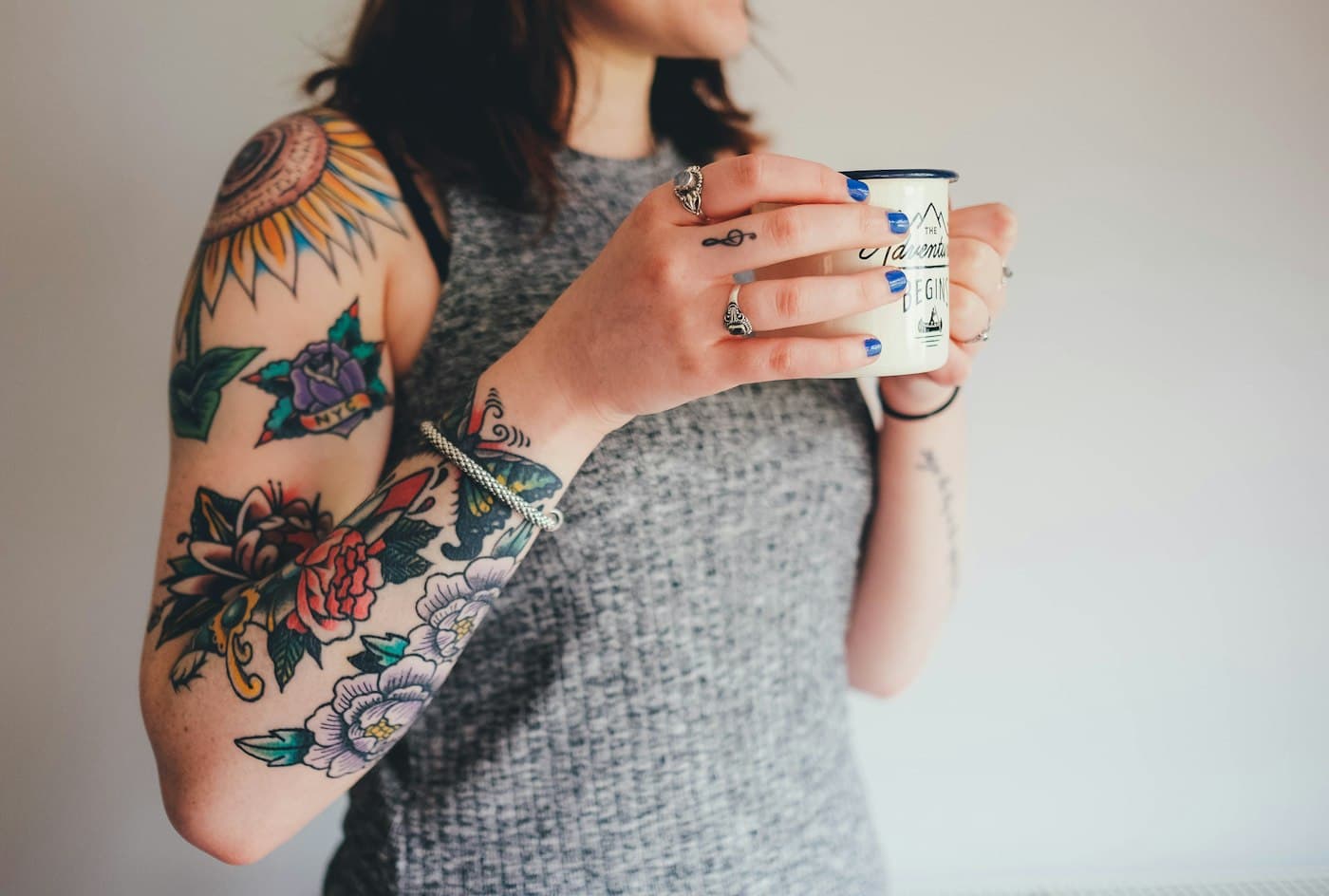 A colour floral tattoo sleeve on an arm